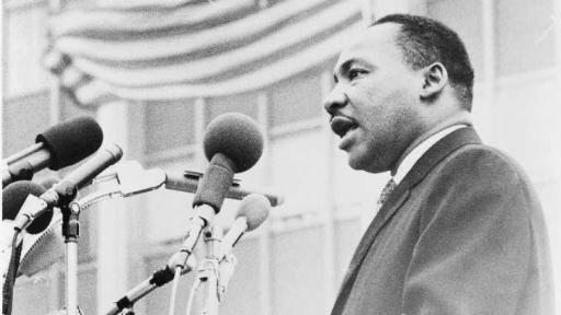 Martin Luther King Jr. at podium with microphones
