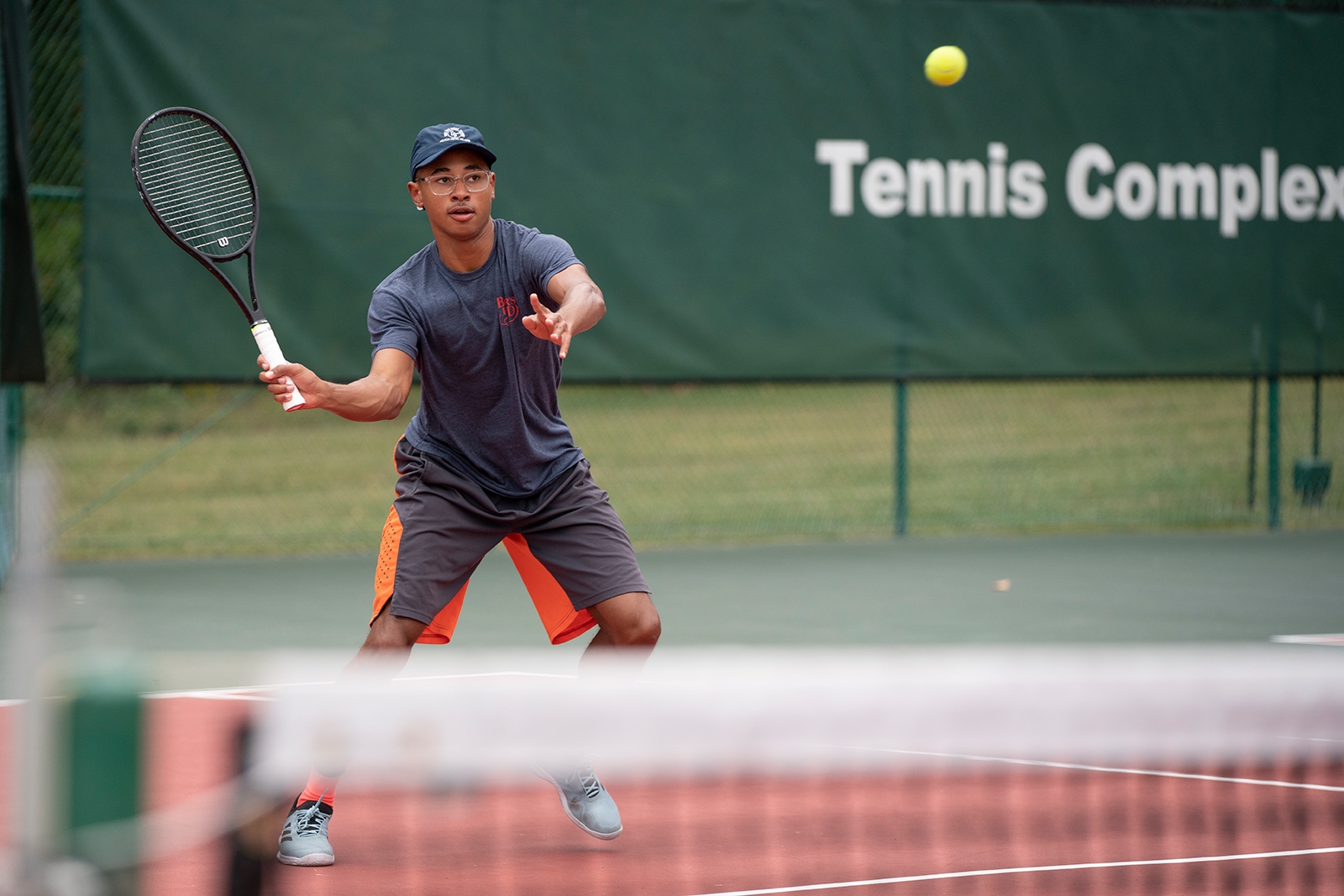 Student playing tennis