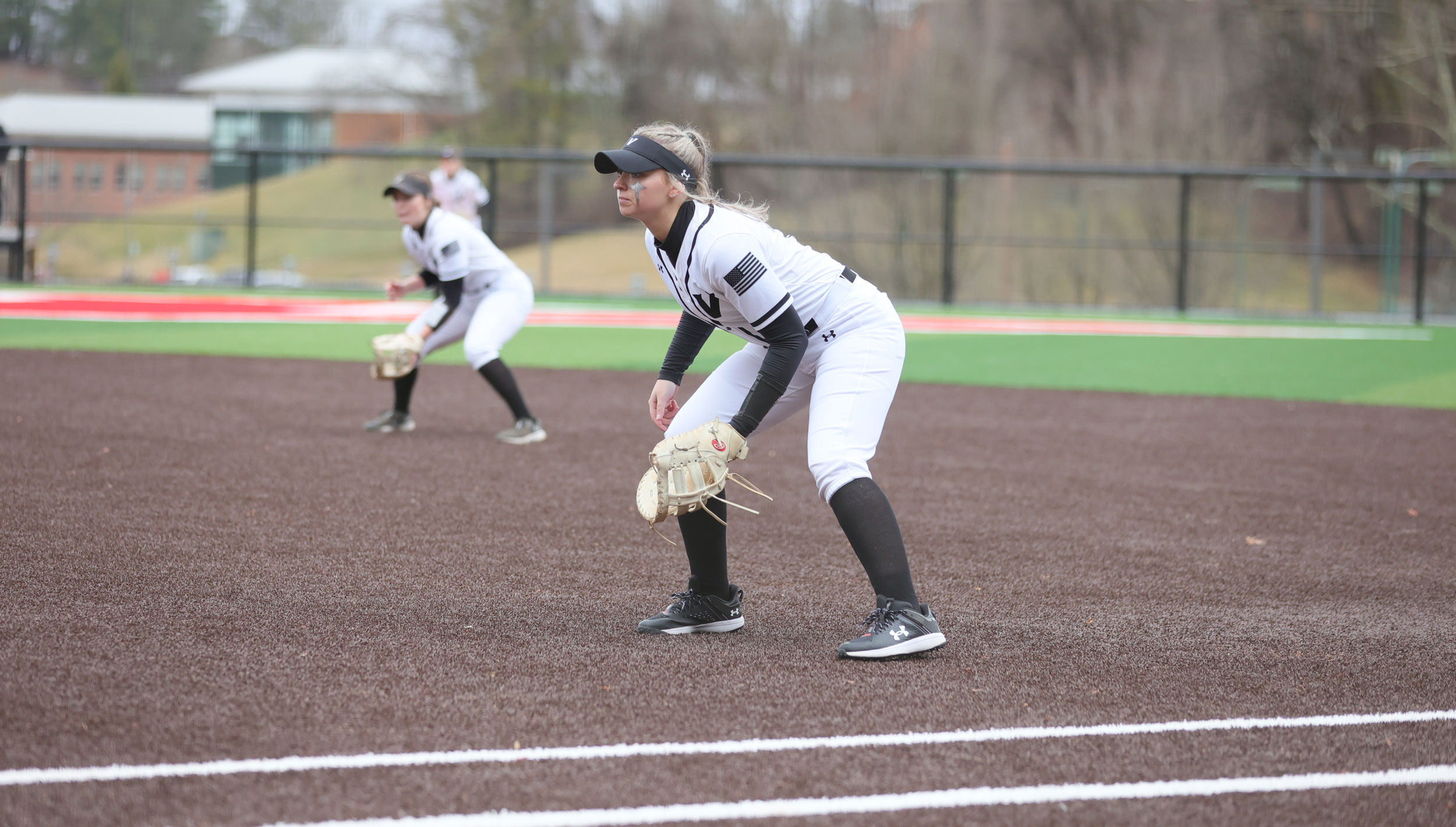 Softball players on field during game