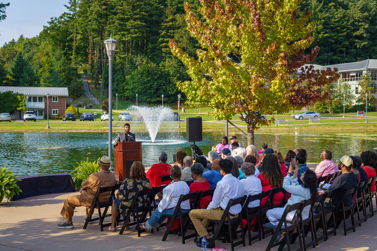 Rows of people seated for bench dedication ceremony