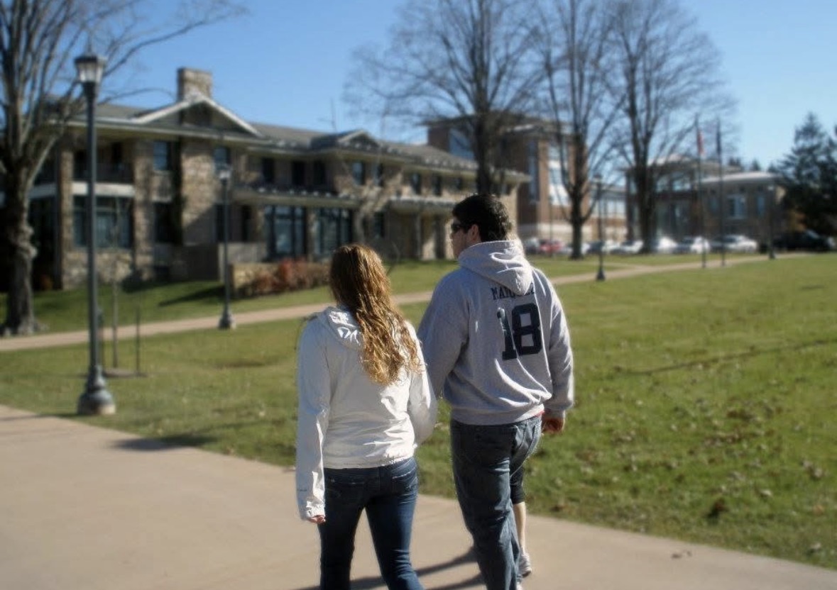 Katie and Christian walking on campus facing away from camera