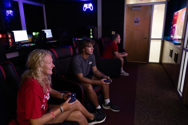 Students playing video games in game room