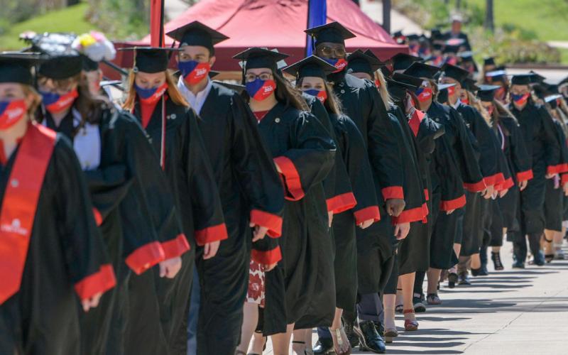 Students lined up in caps and gowns
