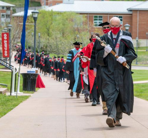 2020 commencement participants walk in to ceremony