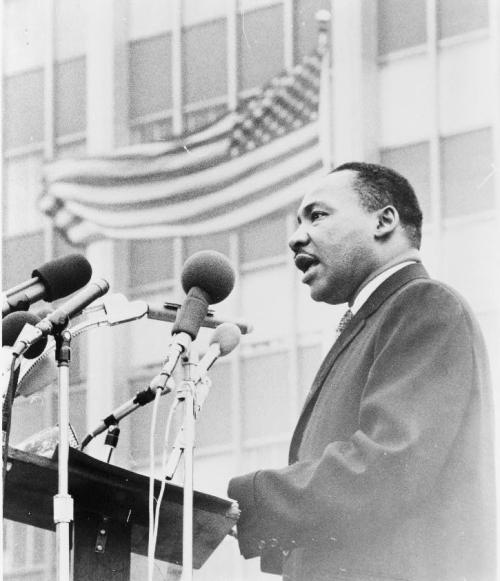 Martin Luther King Jr. at podium with microphones