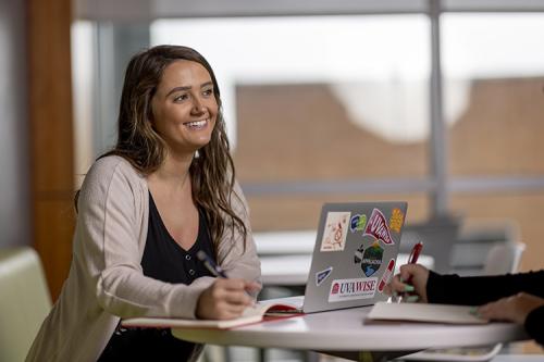 Student studies in sixth floor library lobby