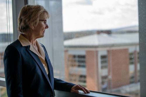 Chancellor Henry looking out window over campus