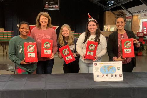 Club advisors and members with shoeboxes