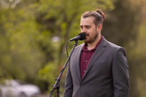 UVA Wise's Robert Arrowood presents at a microphone at the Wise-minster Dog Show.