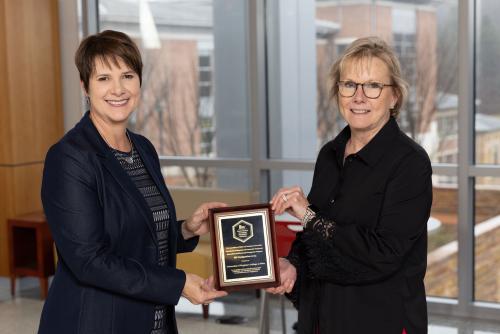 Shannon Blevins and Chancellor Henry with award