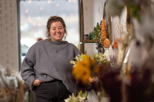 Annie Jordan '23 poses at her new business in downtown Norton.