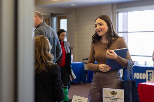 Lauren Montes speaking with employer at career fair