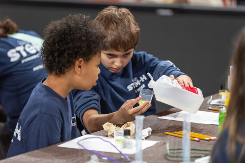 Students participating in stem day experiment