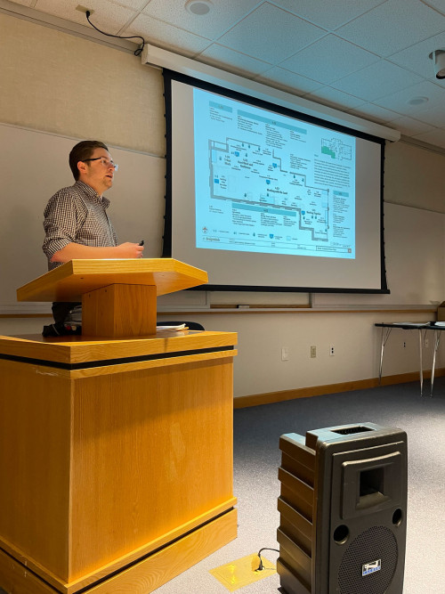 Andrew Hamilton speaking at podium