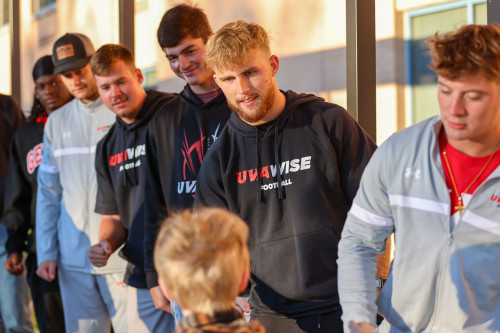 Athletes lined up at fist bump Friday