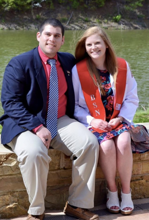 Katie and Christian sitting and smiling 