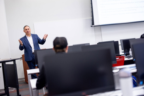 Gurkin Akalin standing in front of classroom
