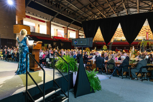 Chancellor Henry faces Benefactors attendees from stage