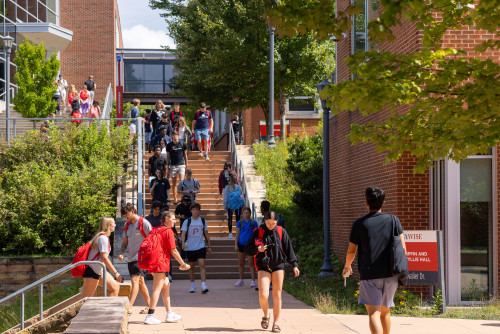 Students walking on sidewalk on campus