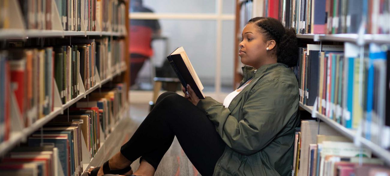 Student reading in library
