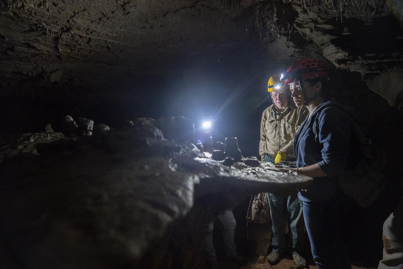 Instructor with student in cave