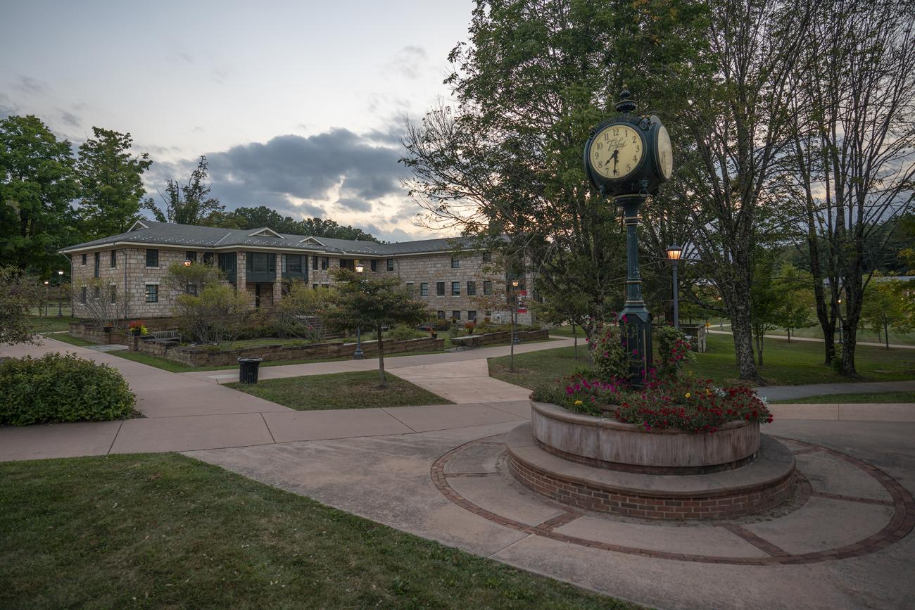 A clock on campus at dusk