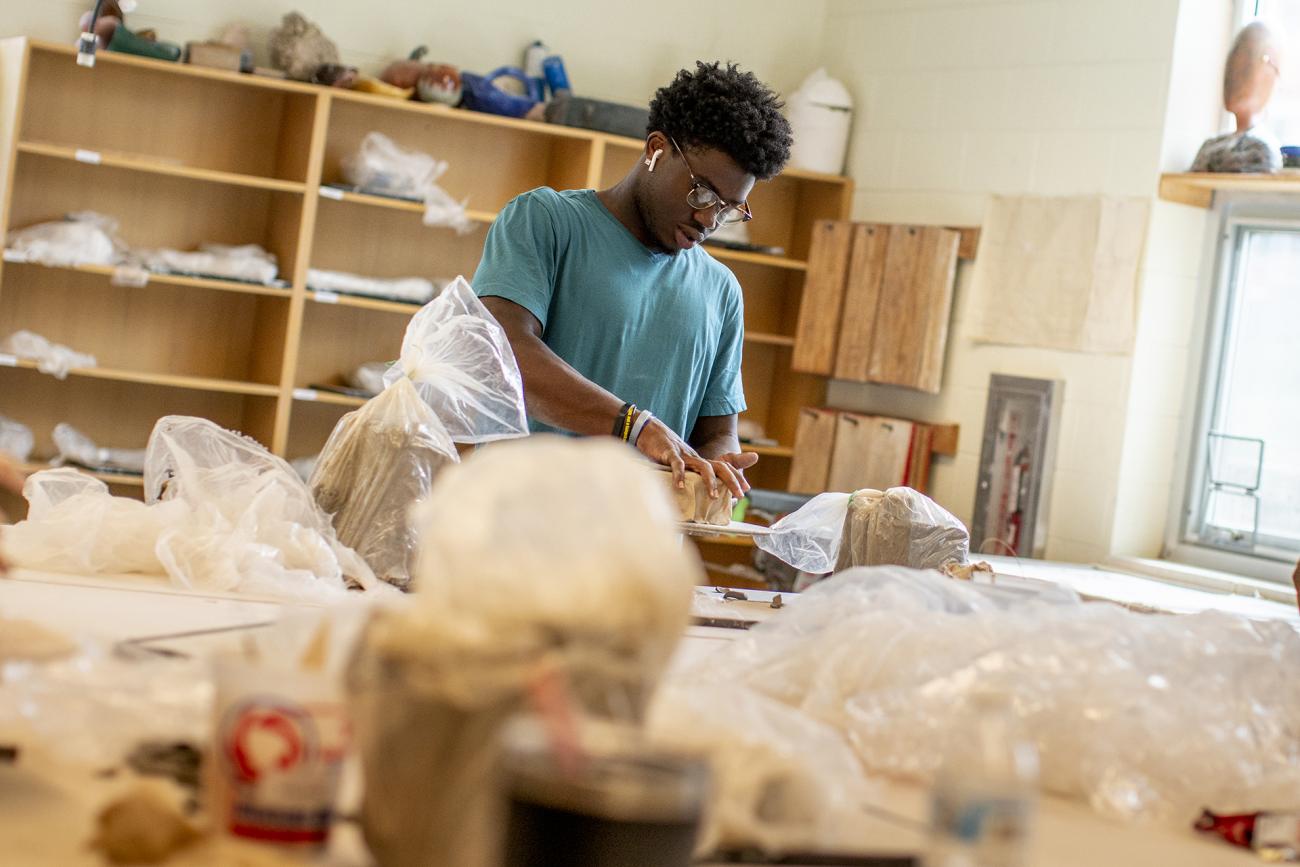 Student in pottery class