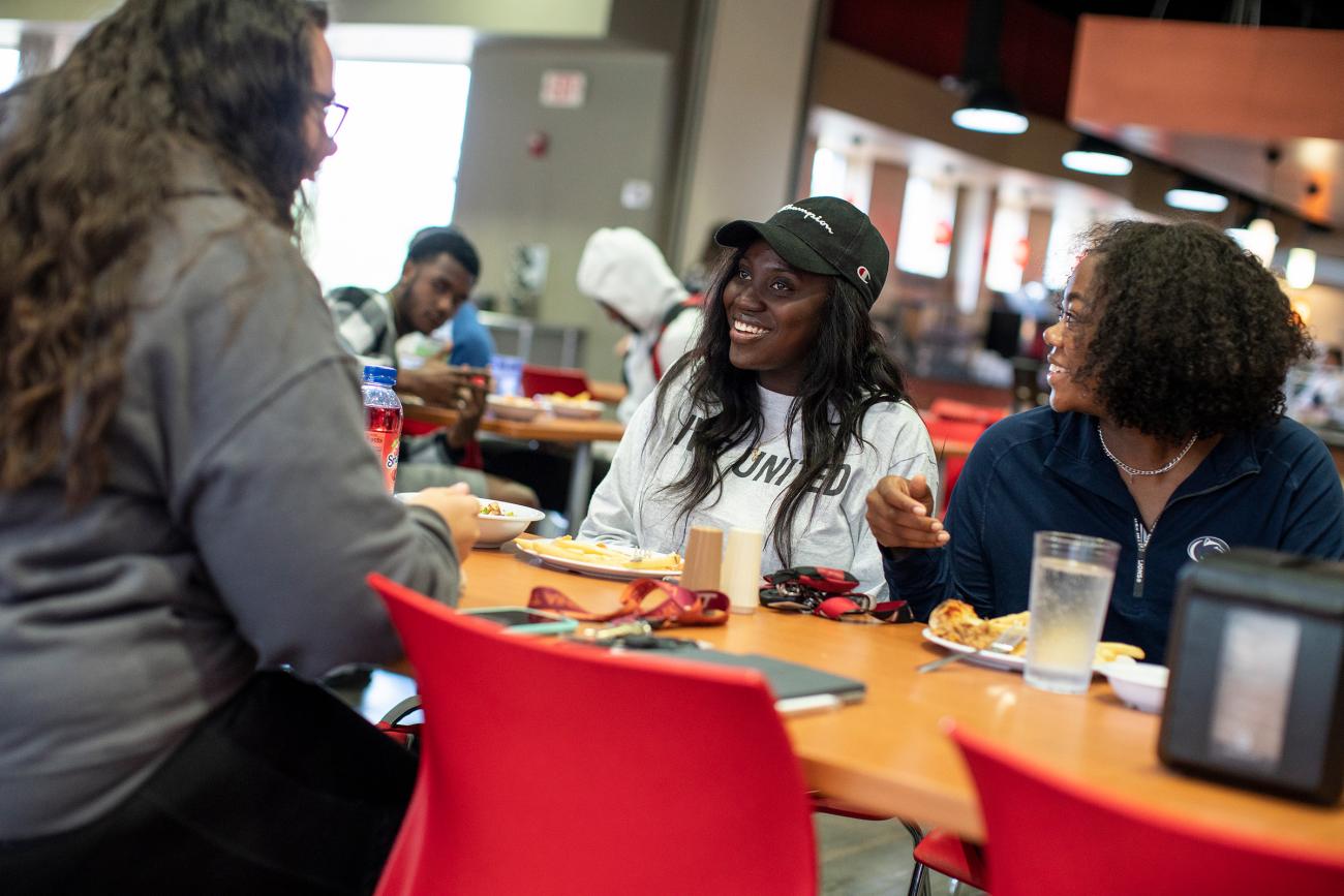 Three women talking in the cafeteria