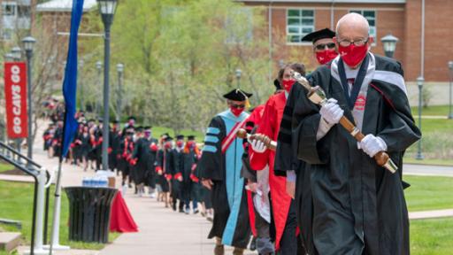 2020 commencement participants walk in to ceremony