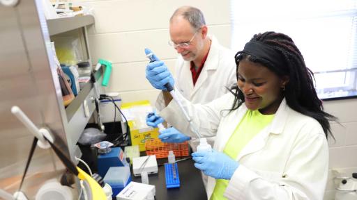 Professor Bruce Cahoon with Hubertine Moyo in lab