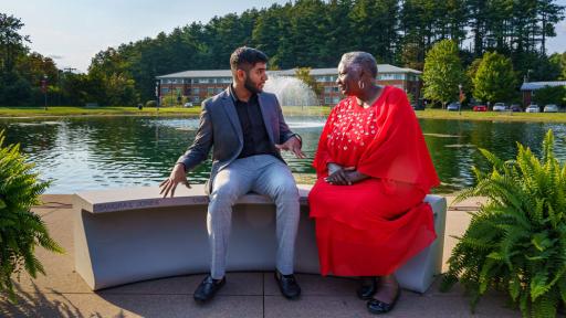 Sanjeev Kumar and Sandra Jones sitting on newly dedicated bench by the lake