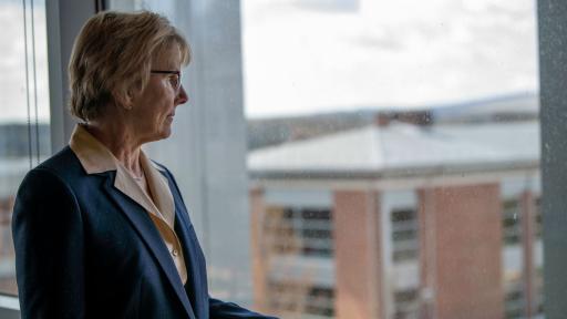 Chancellor Henry looking out window over campus