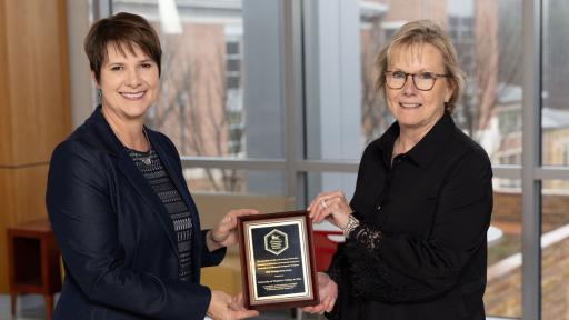 Shannon Blevins and Chancellor Henry with award