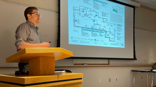 Andrew Hamilton speaking at podium