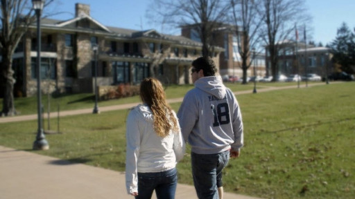  Katie and Christian walking on campus facing away from camera