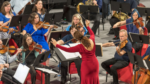 Conductor with musicians in Prior Center