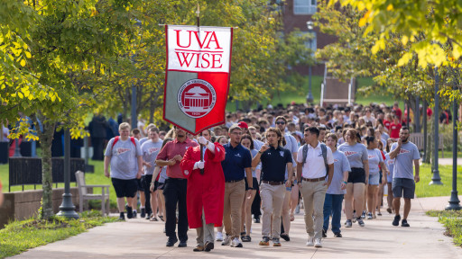 Students walking across campus to Convocation