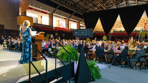 Chancellor Henry faces Benefactors attendees from stage