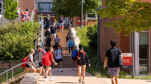 Students walking on sidewalk on campus